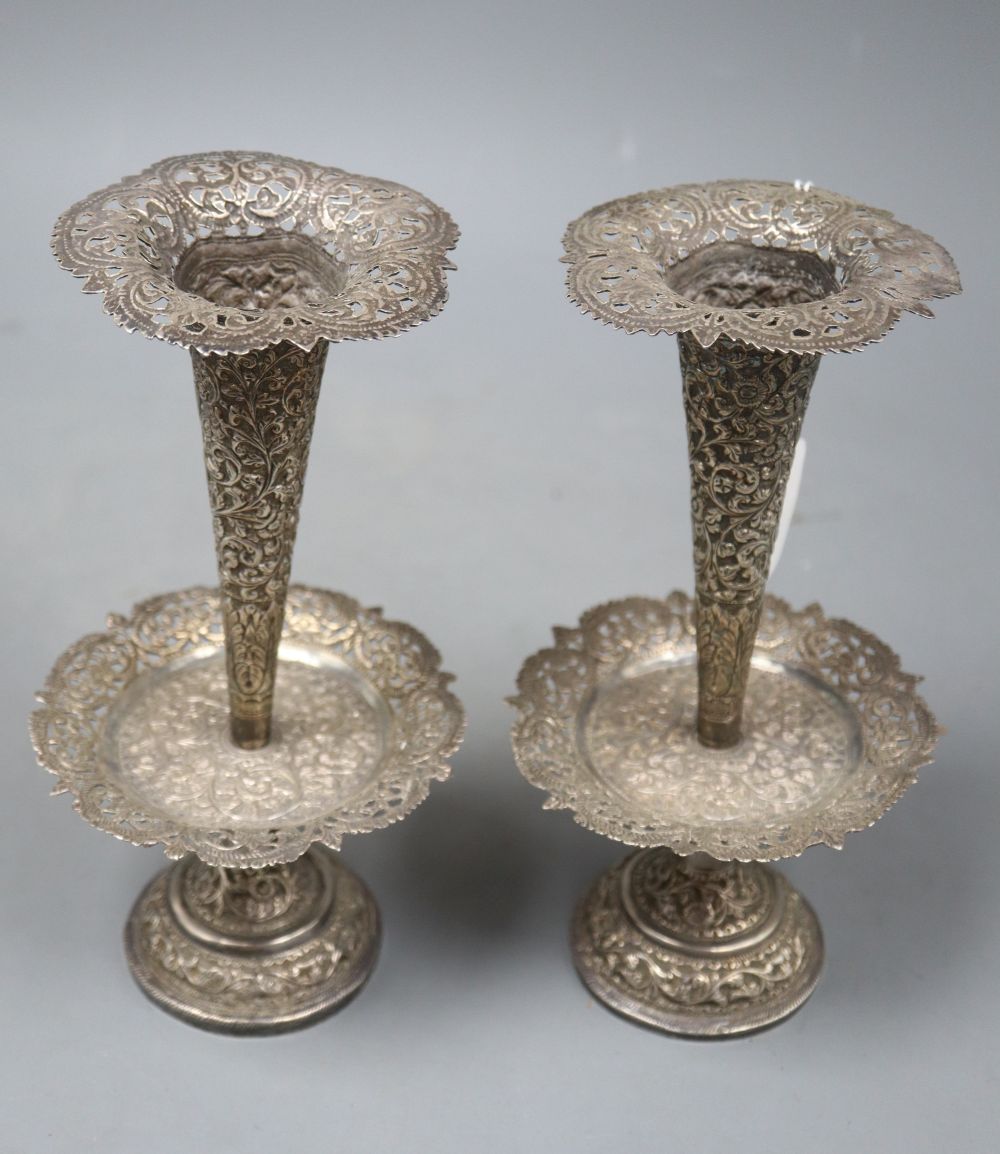 A pair of early 20th century Indian pierced white metal spill vases with drip pans?, 22.2cm, weighted.
